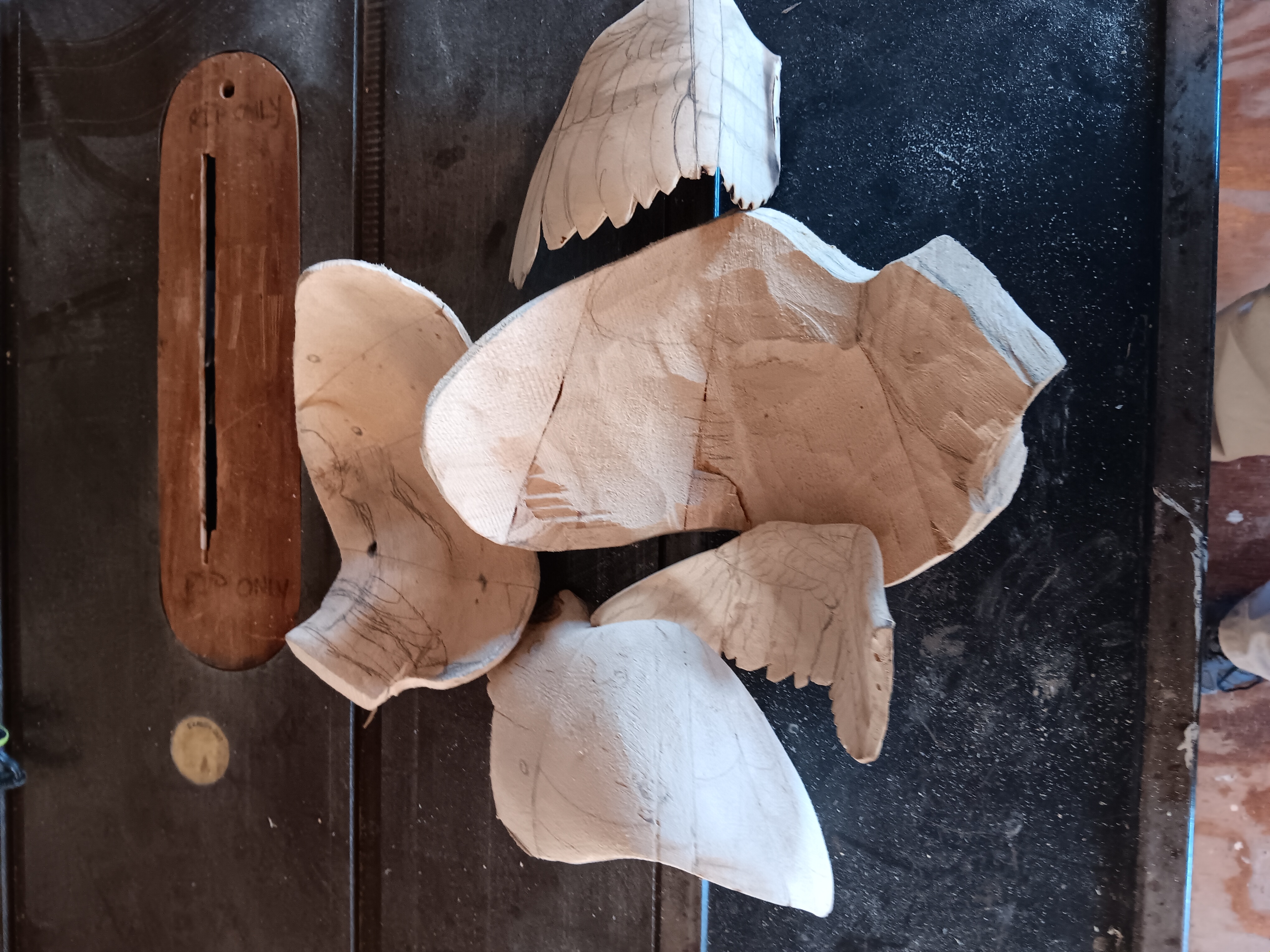 Raw carved owl sculpture before painting
