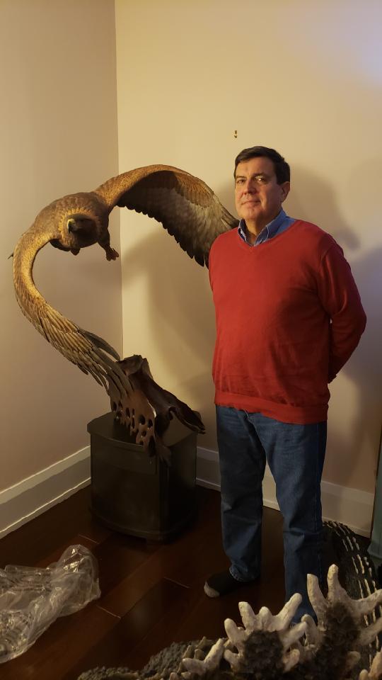 Jeff Demarest standing with his Golden Eagle sculpture