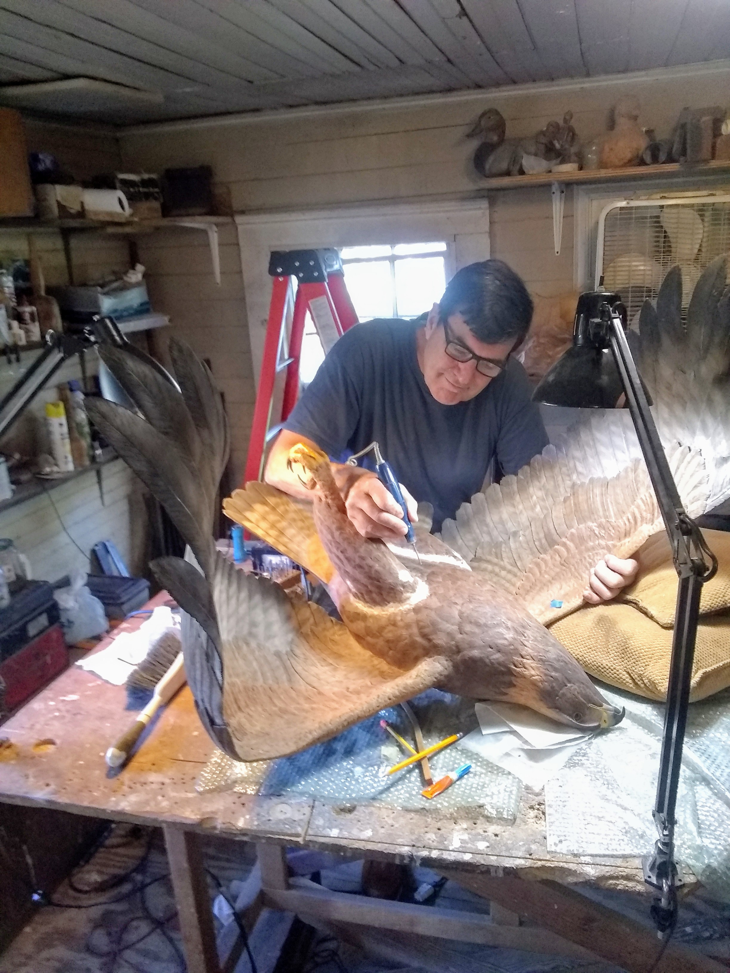 Jeff Demarest painting the Golden Eagle sculpture in his studio